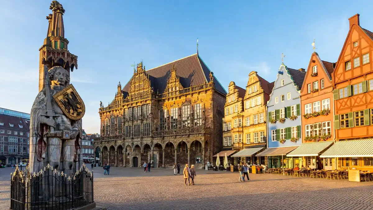 Bremen Marktplatz with the historic Town Hall, Roland statue and colourful gabled merchant houses under a clear sky