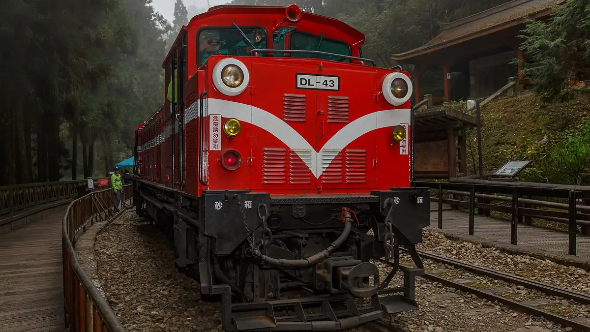 Red Alishan Forest Railway locomotive at a misty forest station in the Taiwan mountains, one of the best places to visit in Taiwan during summer