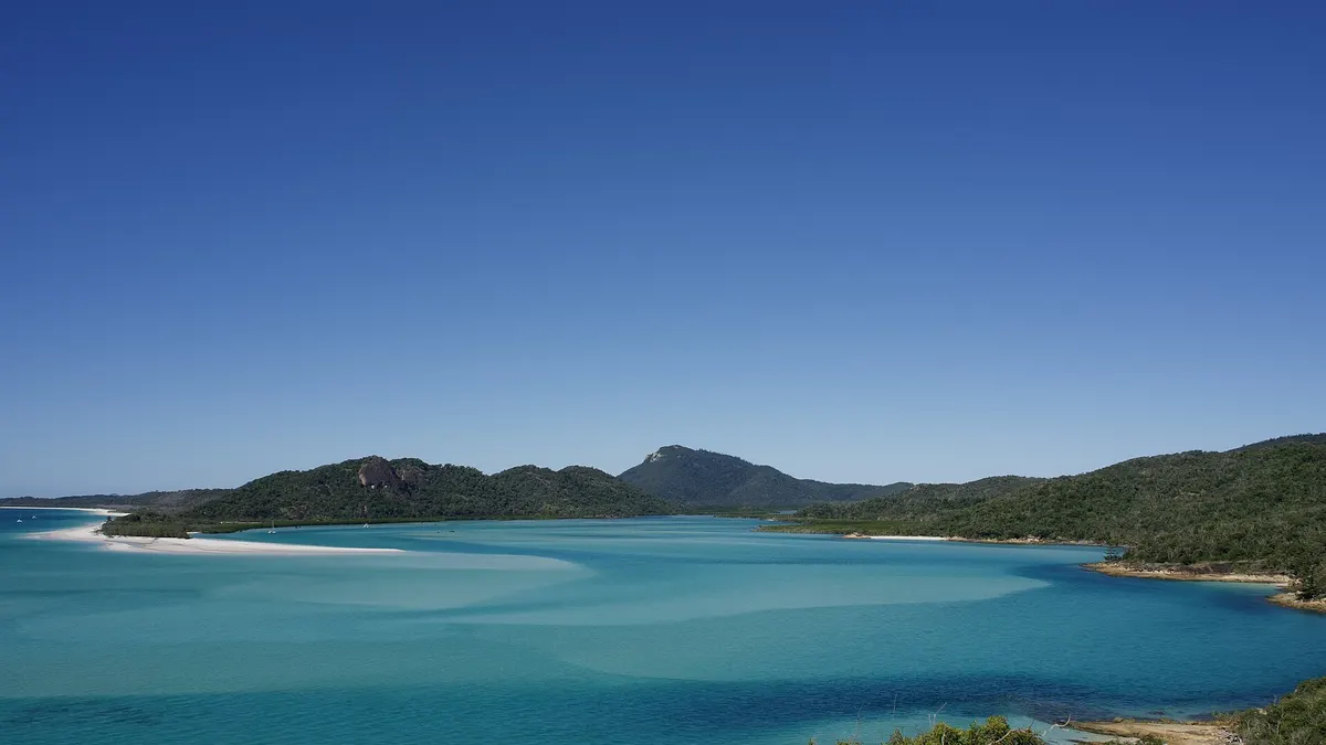 Aerial view of Hill Inlet at Whitehaven Beach in the Whitsundays, Australia, where white silica sand swirls through turquoise water
