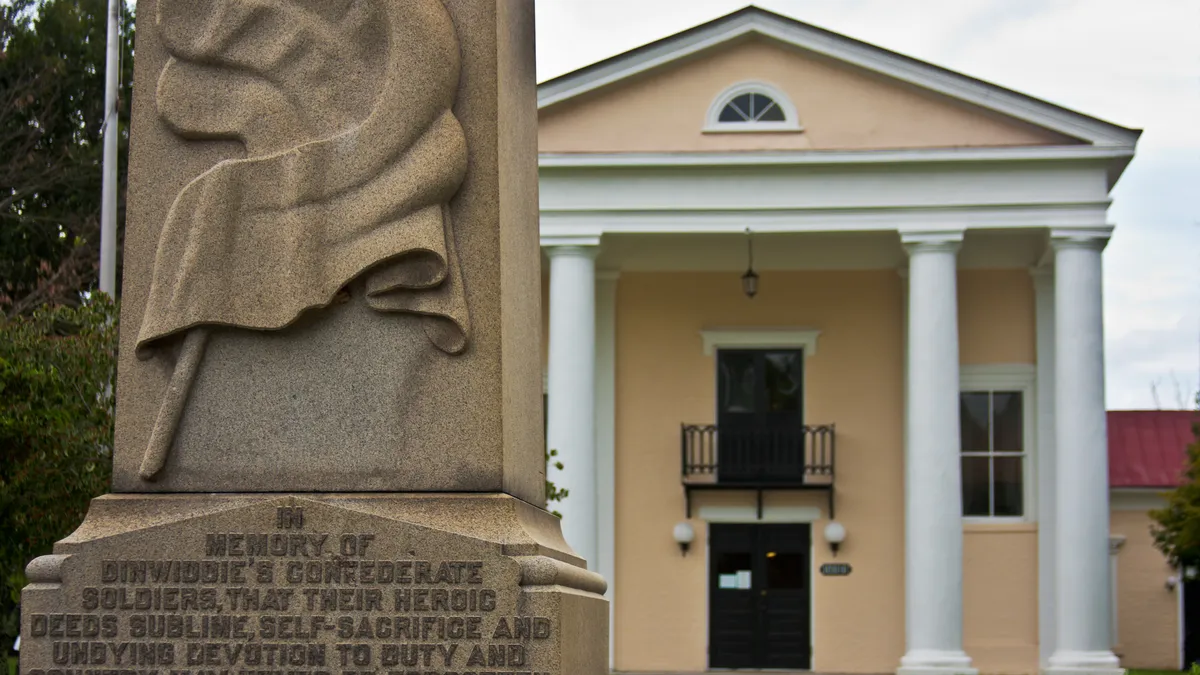 The historic Dinwiddie County Courthouse in Dinwiddie, Virginia, a brick Greek Revival building with a columned portico and green lawn