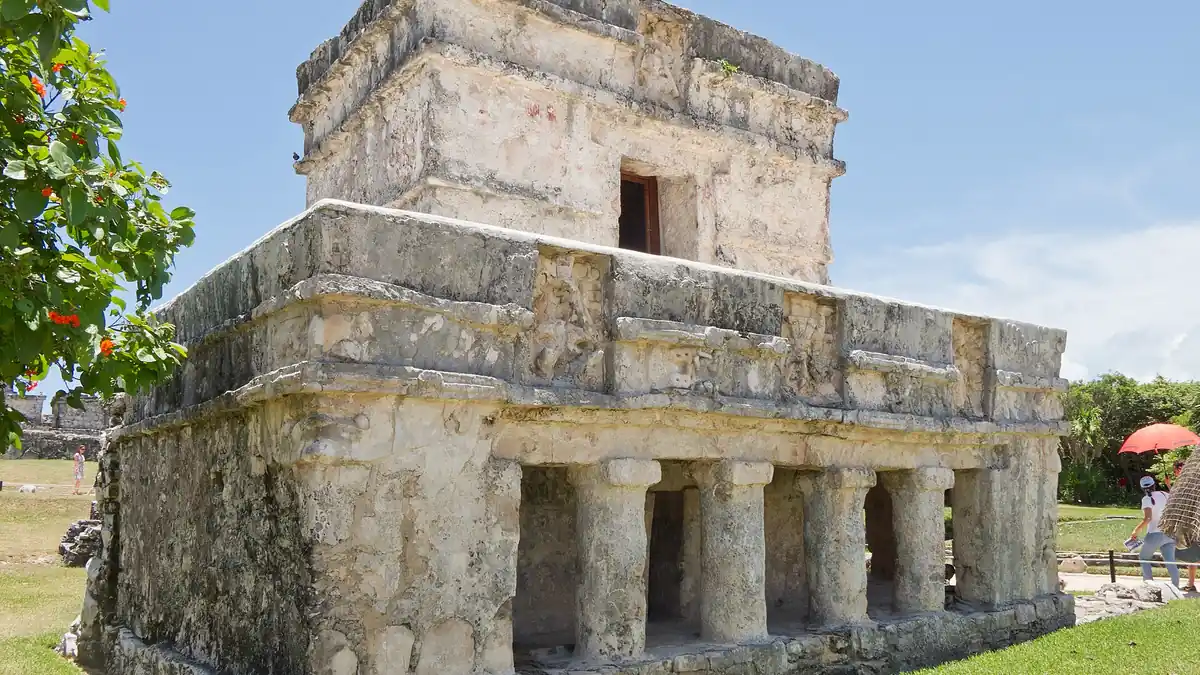 Tulum archaeological site above a turquoise Caribbean beach with palm trees and white sand in Quintana Roo, Mexico