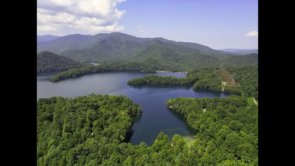 Lake Santeetlah in Graham County, North Carolina, with forested mountains rising around the quiet mountain lake