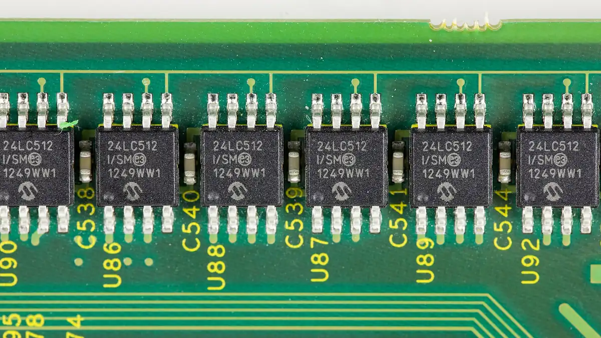 Close-up of a printed circuit board with a microchip and electronic components, representing the hardware behind the latest technology news