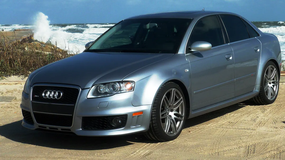 Silver sedan with dark tinted side windows parked near the coast, illustrating legal tint in Connecticut