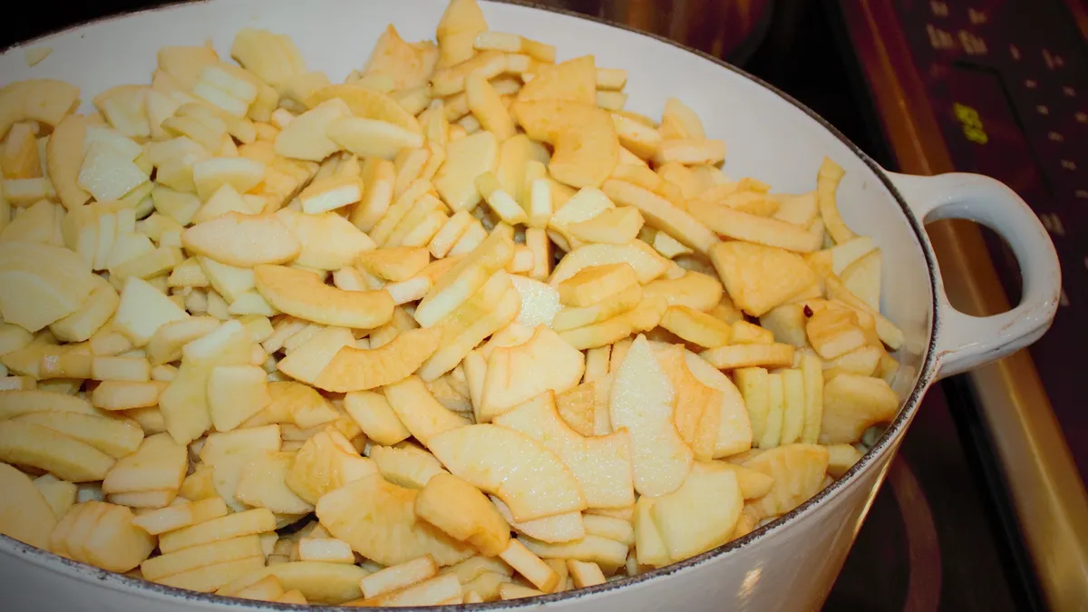 Freshly cut apples prepared for homemade applesauce with a food mill