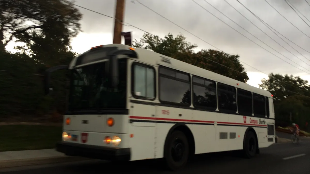 A shuttle bus providing a regular staff and campus transport service on a city route