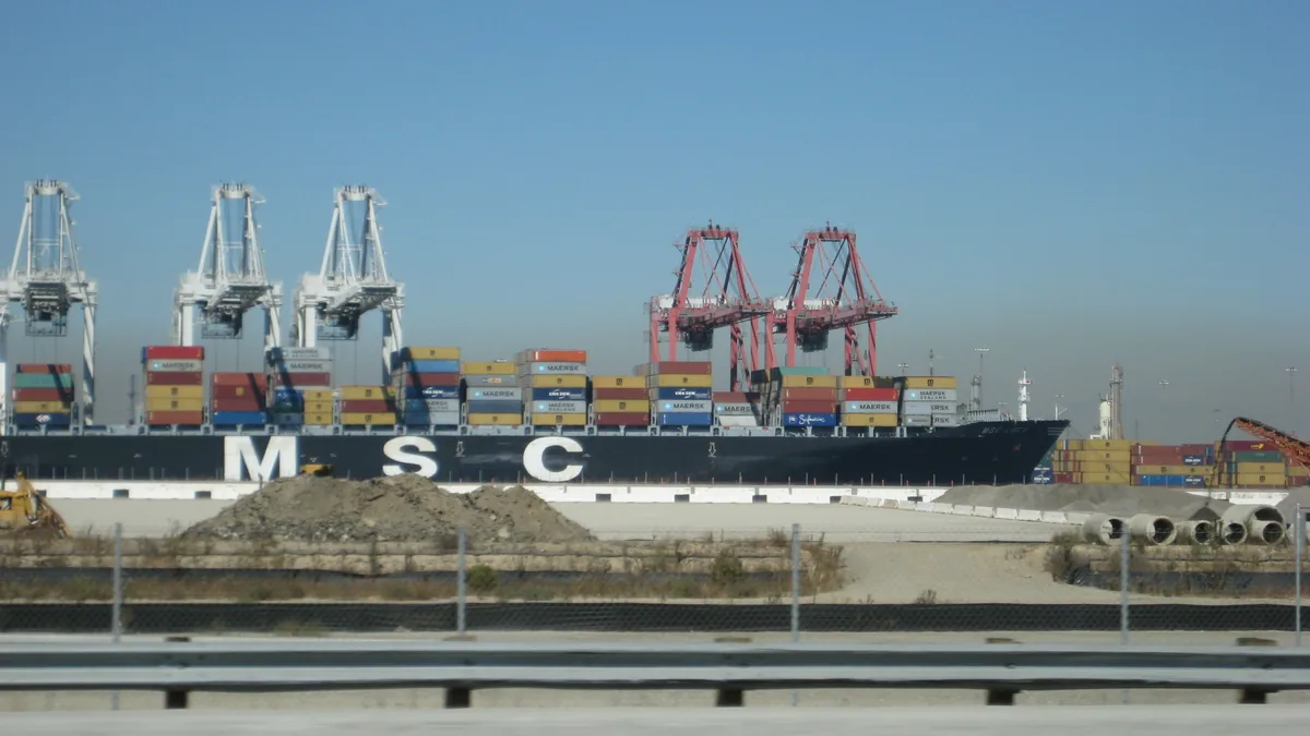 Container ship being loaded by port cranes at a container terminal