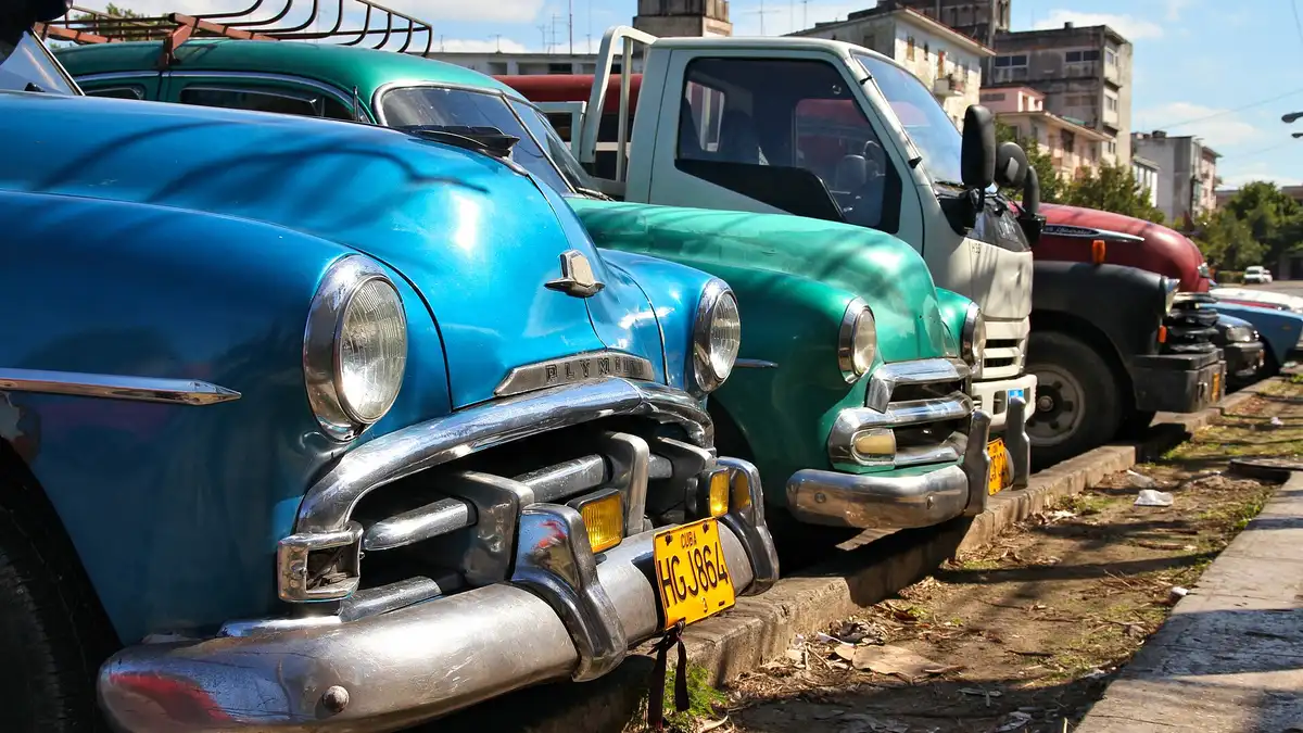 Classic American cars parked along a colourful street in Havana, Cuba