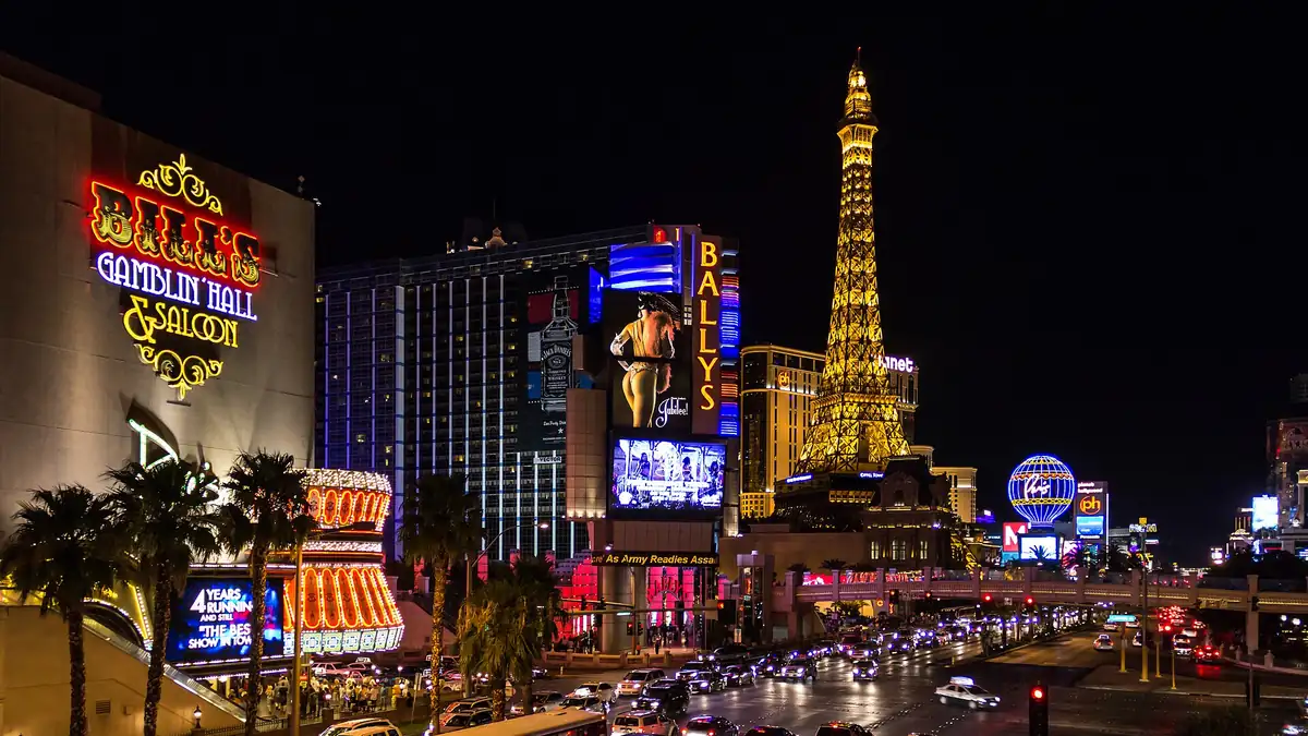 The Las Vegas Strip at night with illuminated resort towers, neon signs and traffic along Las Vegas Boulevard