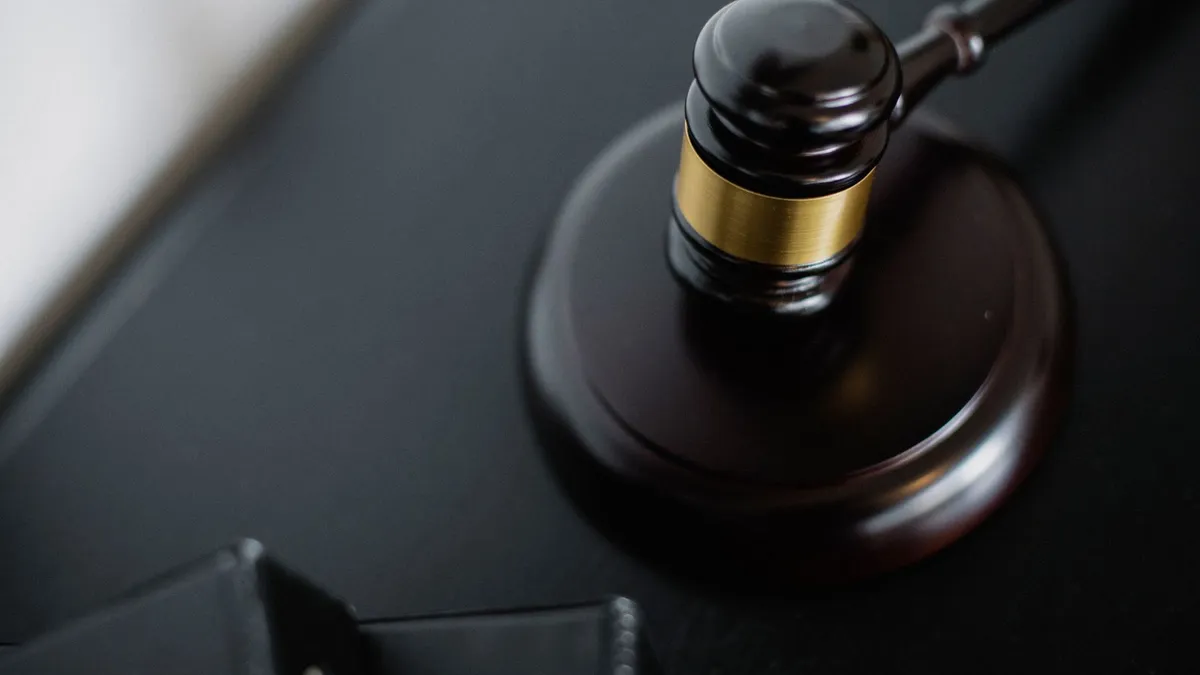 Dark wooden judge's gavel with a brass band resting on its sounding block, symbolising a Pennsylvania PFA court order