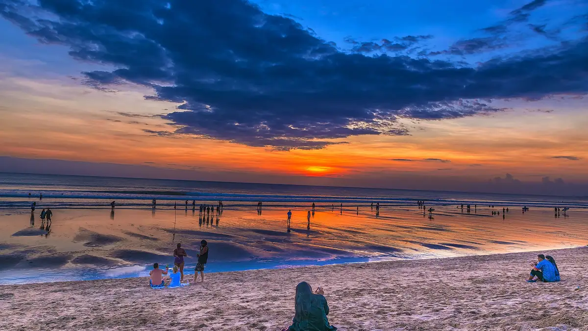 Kuta Beach in Bali with people enjoying the wide sandy shoreline and surf