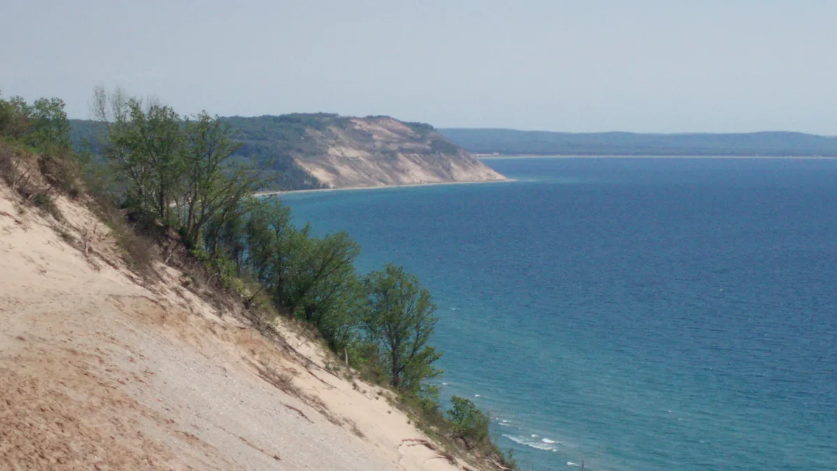 Sleeping Bear Dunes rising above the blue water of Lake Michigan in summer, Michigan