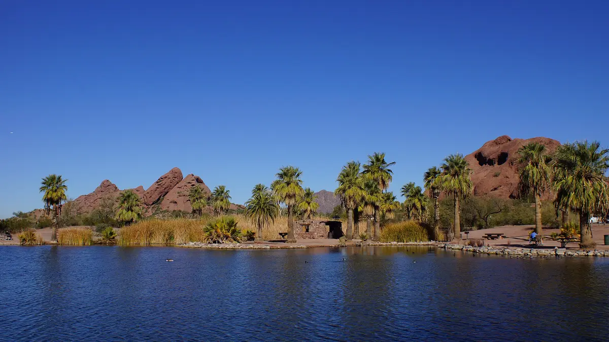 Papago Buttes and Hole in the Rock in Papago Park, Phoenix, with Camelback Mountain in the distance