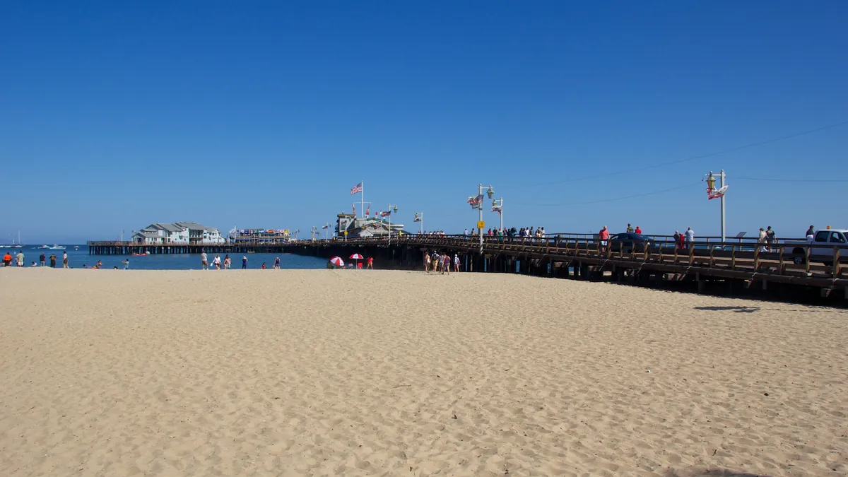 Santa Barbara beach and Stearns Wharf stretching into the Pacific with palm trees and mountains behind
