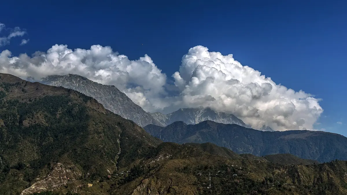 McLeodganj town nestled on a green hillside below the Dhauladhar range near Dharamshala in Himachal Pradesh