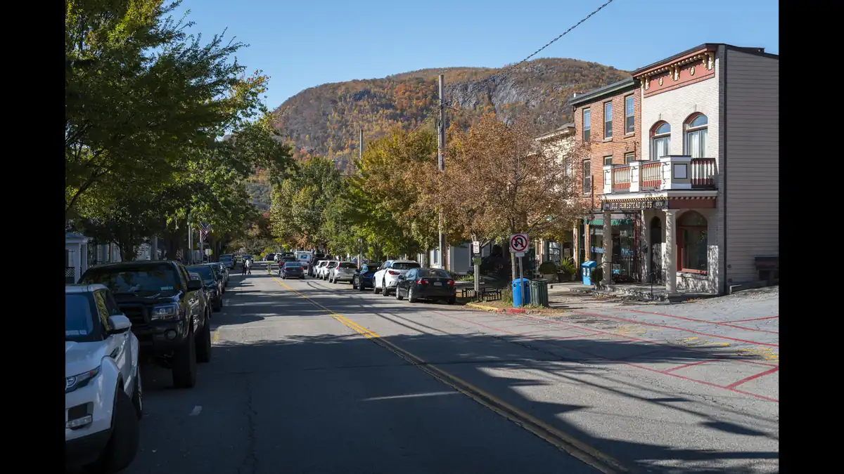 Main Street in Cold Spring, New York, with historic storefronts and the Hudson Highlands rising behind the village on a long weekend escape from the city