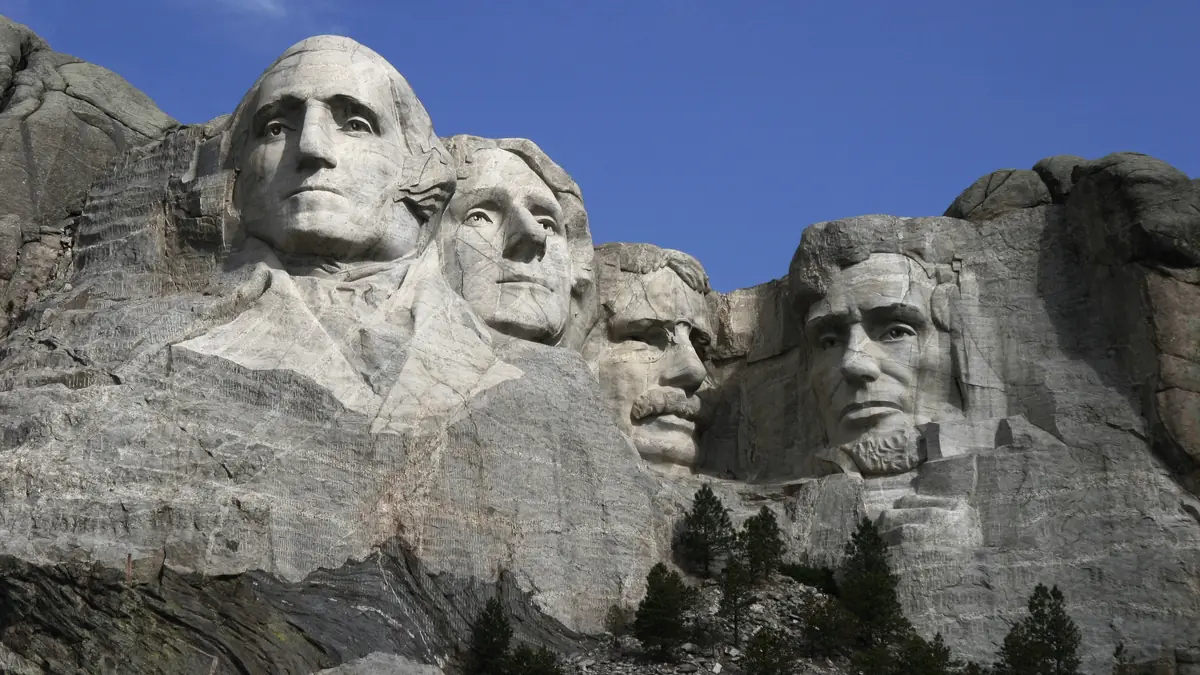 The four presidential faces of Mount Rushmore carved into granite above pine trees in the Black Hills near Rapid City, South Dakota