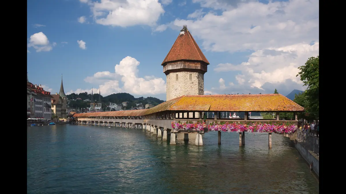 The Chapel Bridge and Water Tower over the River Reuss in Lucerne, the classic first stop on a day trip by train from Zurich