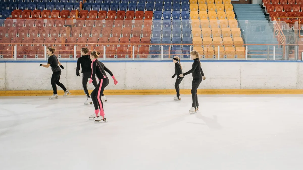 Young figure skaters practising together on an indoor ice rink