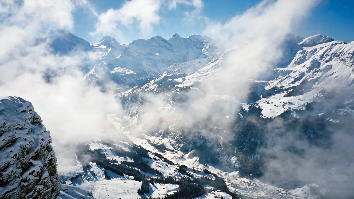 Lauterbrunnen valley in summer with green meadows, steep cliffs and waterfalls in the Bernese Oberland, Switzerland