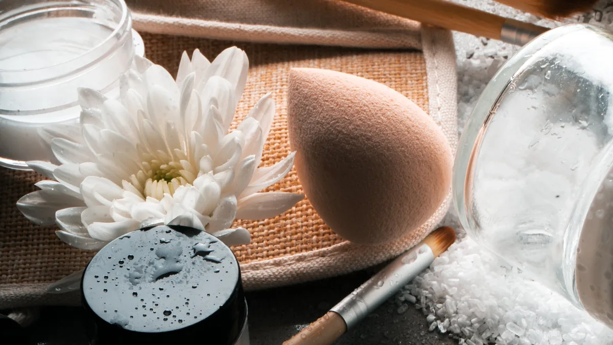 An assortment of makeup and beauty products laid out on a dark table, representing the cosmetics and beauty essentials found in a beauty supply store