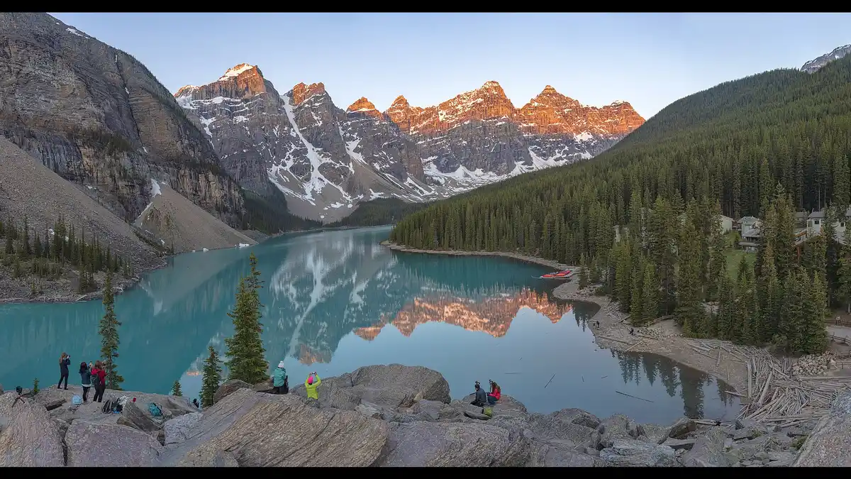 Moraine Lake at sunrise in Banff National Park, Canada, with turquoise water reflecting the snow-capped Canadian Rockies