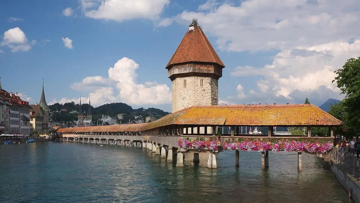 Chapel Bridge and the Water Tower in Lucerne, Switzerland, with flower boxes over the River Reuss